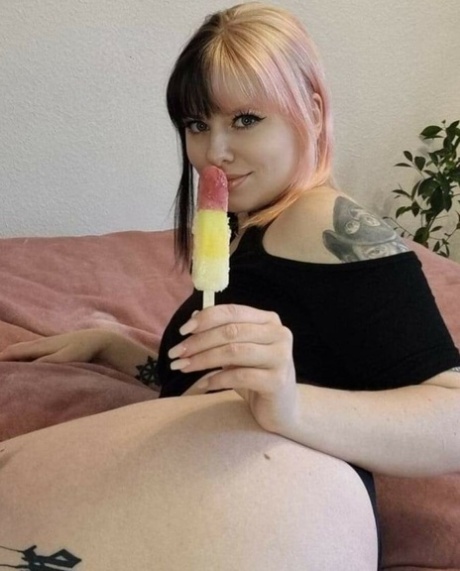 Tattooed babe shows off her big ass while teasing in black lingerie